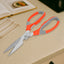Multi-function kitchen scissors with a magnetic sheath for safe storage on a kitchen counter.