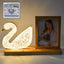Duck-shaped crystal LED lamp glowing softly with photo frame