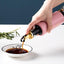 Vastate 300ml olive oil dispenser with a non-drip spout, shown against a clean kitchen background.