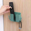 Compact wallmount mobile stand with integrated hook, holding a smartphone and keys.