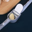 Aluminum garlic press on a kitchen counter, ready for use.