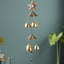 Dragonfly wind chime hanging outdoors with vibrant colors and soothing tones