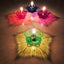 A vibrant Diwali Diya Set of 12 multicolor plastic candle holders glowing warmly.