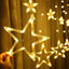 A cluster of glowing Star Curtain Lights creating a festive window display.