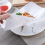 Oil-absorbing cooking paper sheets on a plate with fried food, reducing grease.