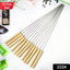 Close-up of a single stainless steel BBQ skewer with ergonomic wooden handle.