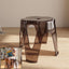 Modern lightweight plastic sitting stool with arch-leg design