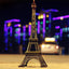 Antique finish Eiffel Tower statue on a white background.