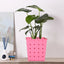 Square dotted railing planter for a single plant, enhancing a modern balcony.
