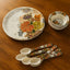 18-piece plastic dinner set with floral design, showing plates, bowls, and spoons.