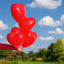 Set of four vibrant heart shaped balloons for party decorations.