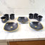 Elegant seashell ceramic cup set with matching plastic bowls arranged for serving.