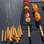 Pack of 12 stainless steel barbecue skewers with ergonomic wooden handles.