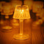 A close-up of the transparent crystal table lamp casting intricate light patterns.