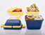 Blue 3-compartment airtight lunch box with ergonomic handle & secure push lock.