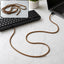 Mixed colour spiral cable protector sleeve wrapped around a charging cable.