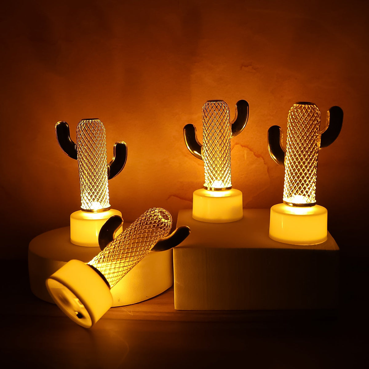 Set of four Cactus Shaped Flameless LED Candles displaying a warm, flickering glow against a dark background. Main image