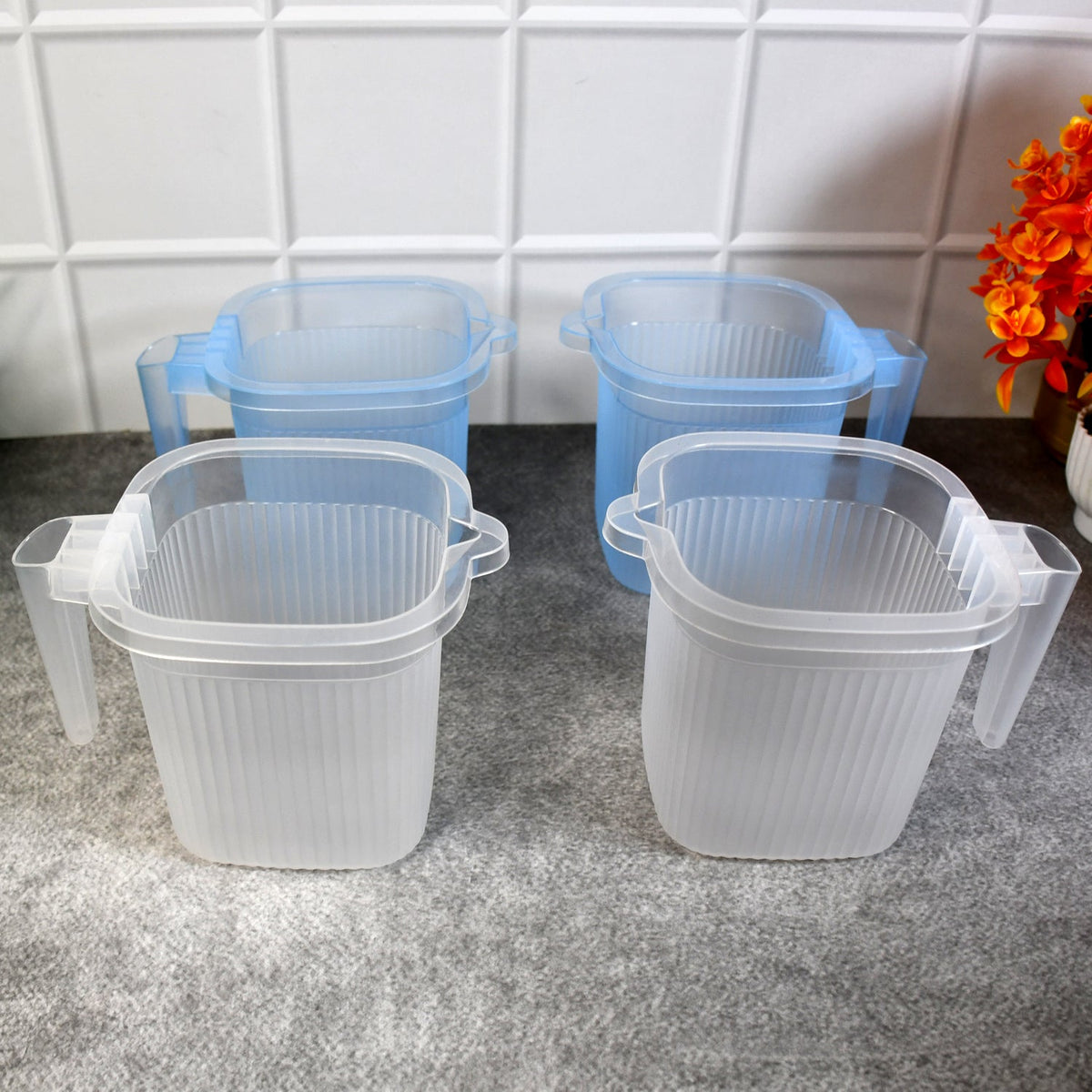 A set of four transparent plastic bathroom mugs in mixed colours, showcasing their 1000 ML capacity. Main image