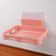Self adhesive soap dish holder with open slatted design mounted on wall