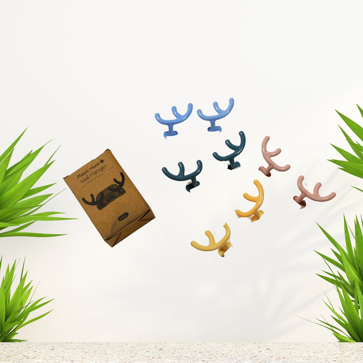 A pack of four white self-adhesive wall hooks, ready for easy installation. Main image