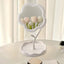 Flower-shaped makeup mirror providing clear reflection with integrated tray for essentials