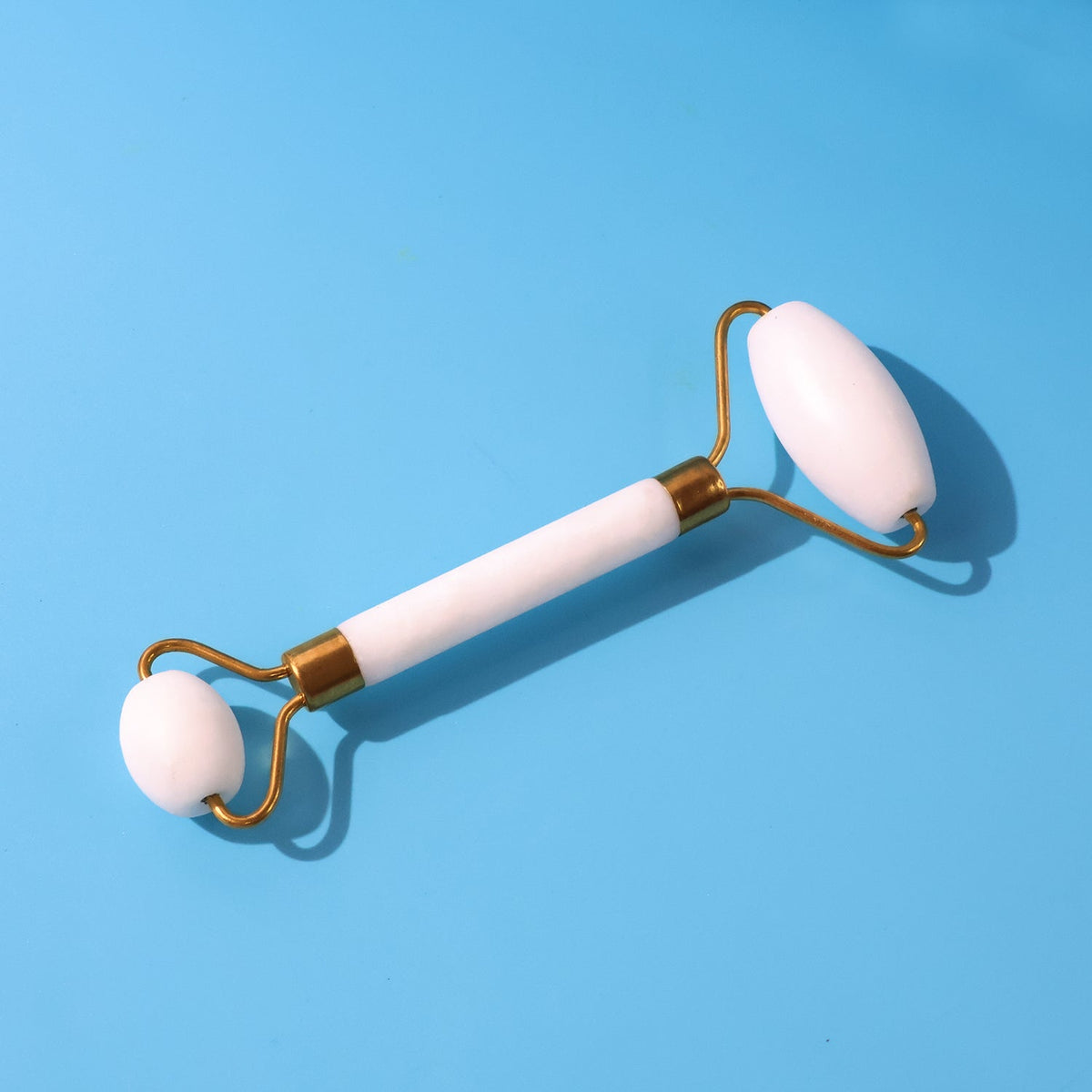 Dual-ended face massage roller with cooling stone heads on a clean background. Main image
