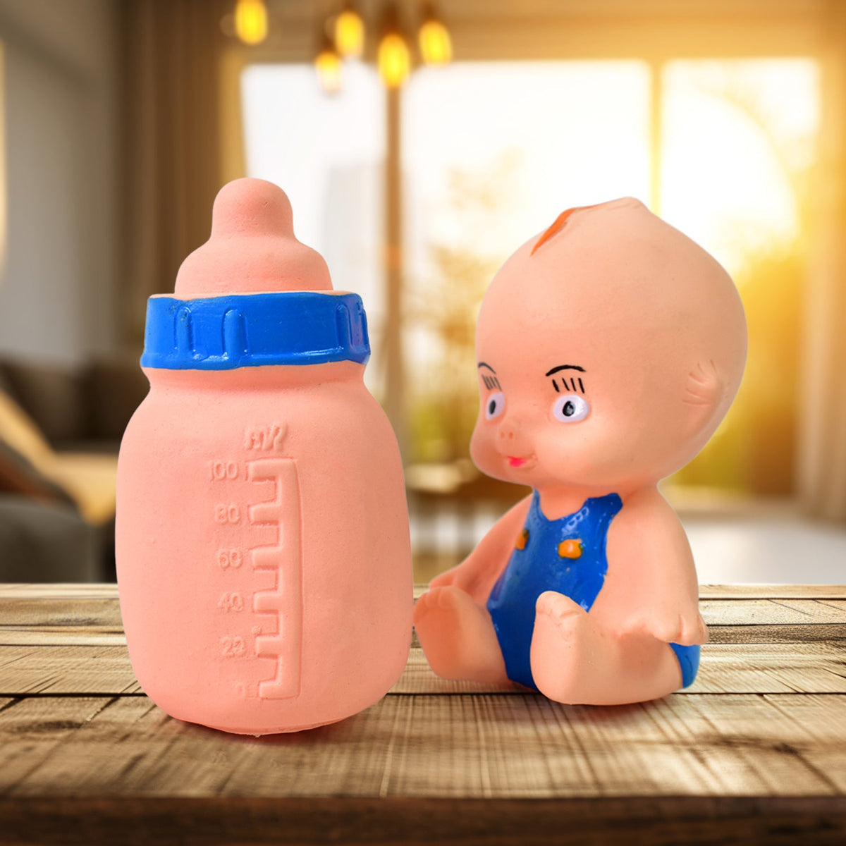 Aditi baby squeeze toy set with a yellow baby figure and milk bottle. Main image