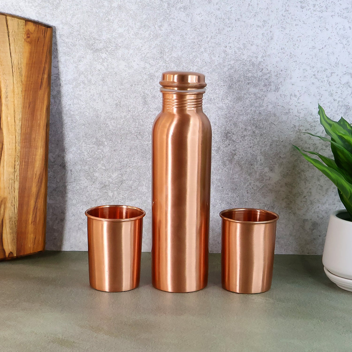 Elegant Copper Water Bottle Set with two matching glasses, presented in a gift box. Main image