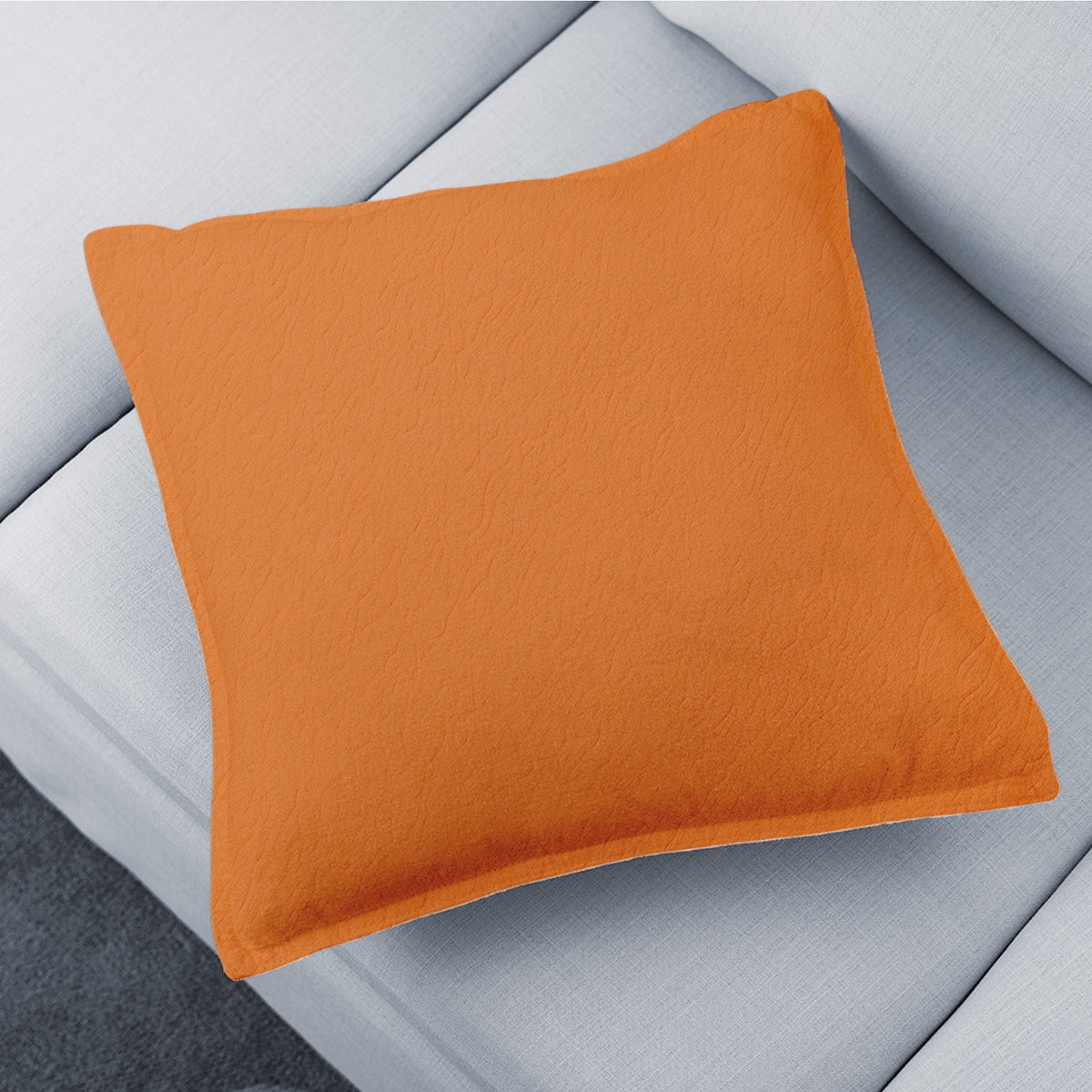 A stylish brown decorative pillow cover on a sofa, adding warmth to the living room. Main image