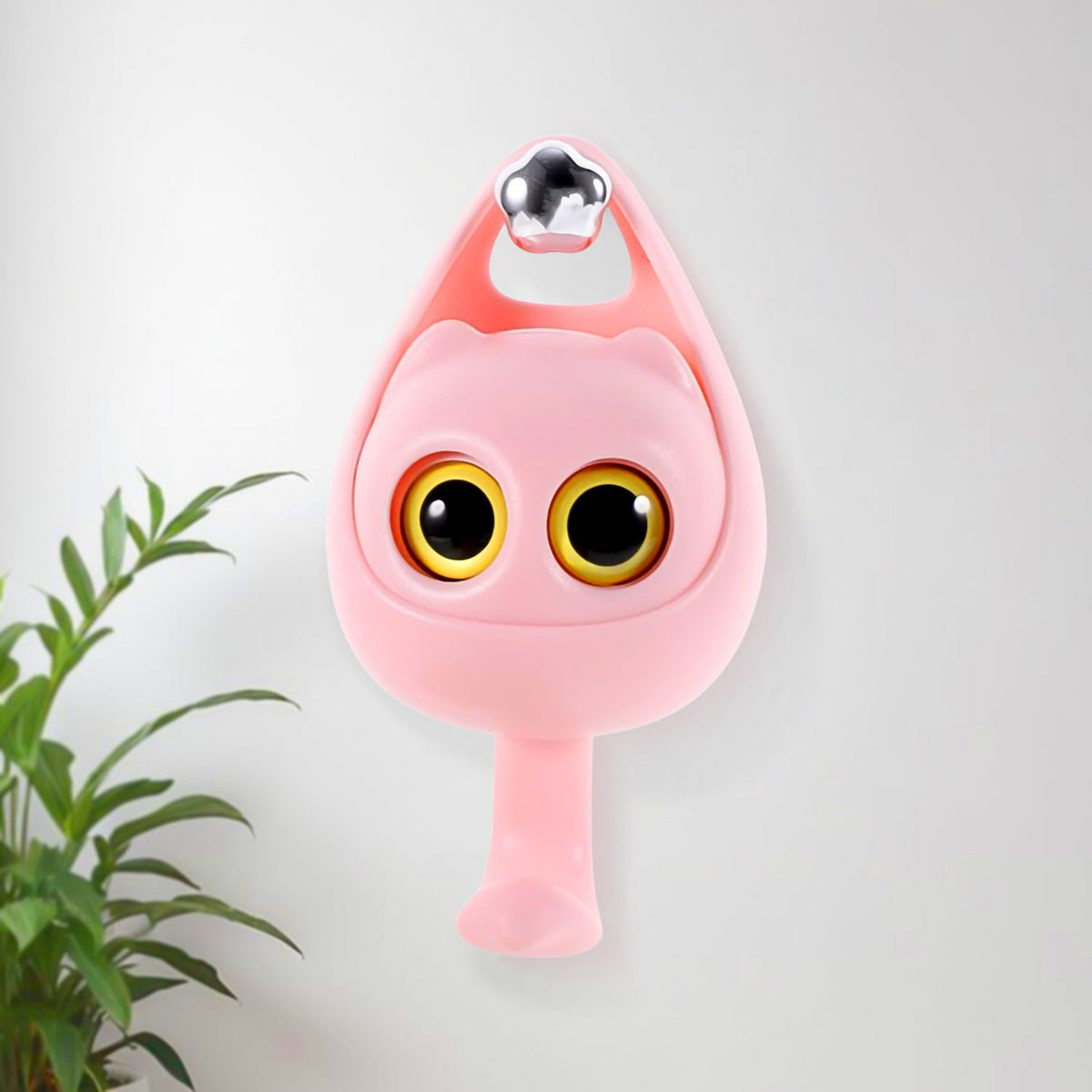 Cute wink cat adhesive coat hook securely holding keys on a bedroom wall. Main image