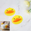 Duck silicone hot pot holder lifting a hot pot lid with secure grip