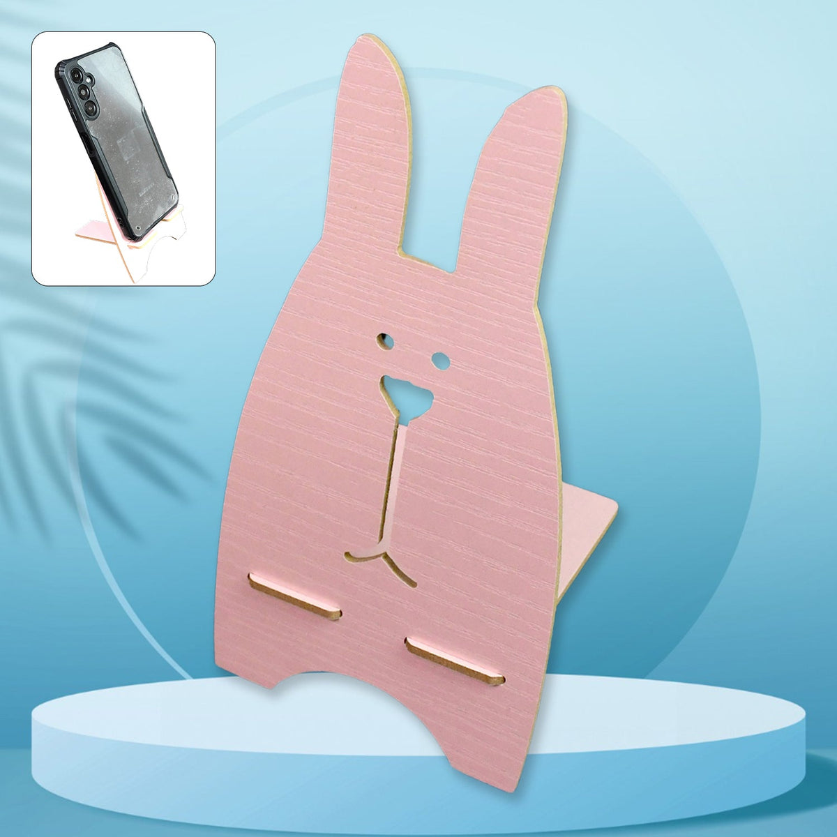 Front view of the wooden rabbit mobile stand holding a smartphone on a desk. Main image