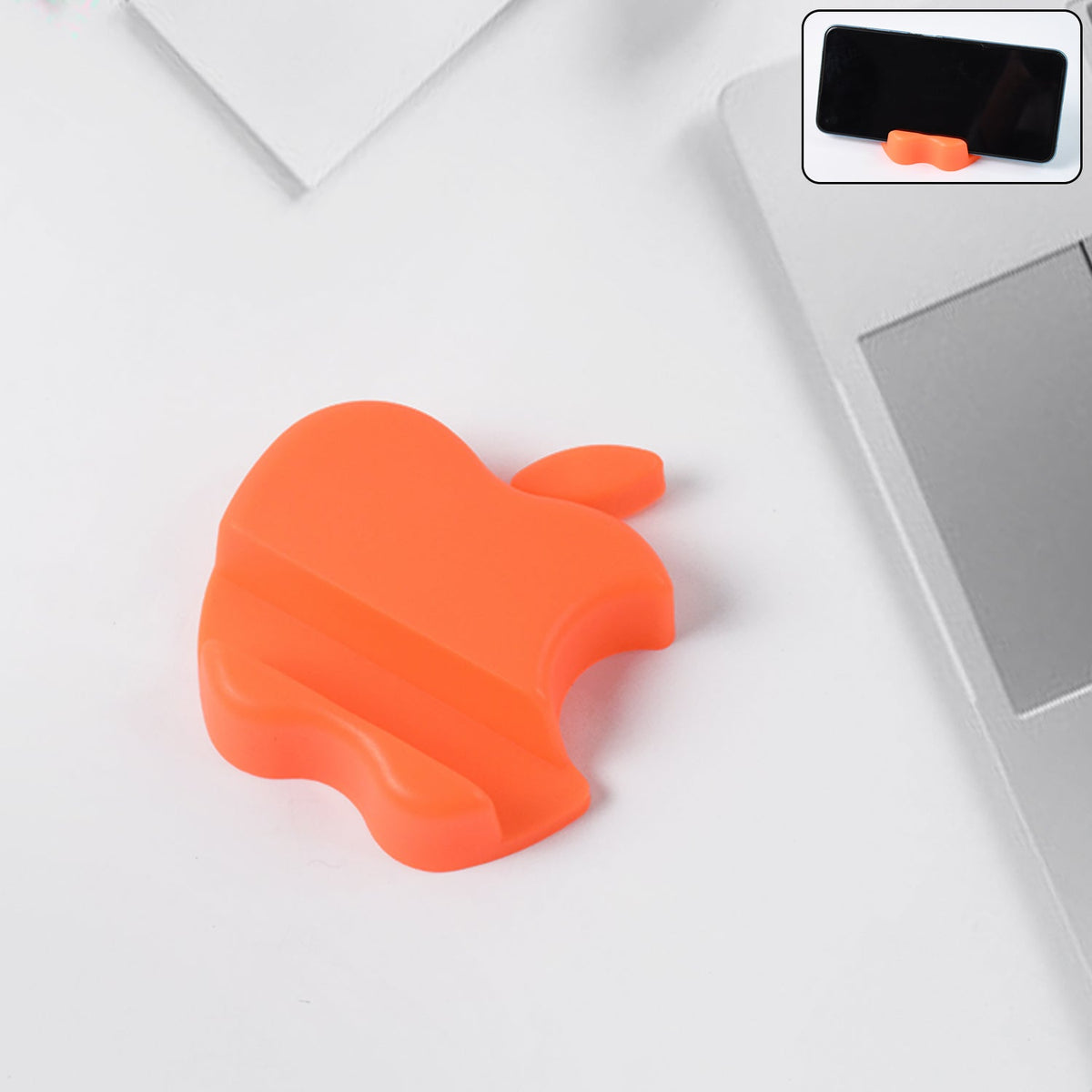 Apple-shaped plastic mobile phone holder in assorted colors on desk Main image