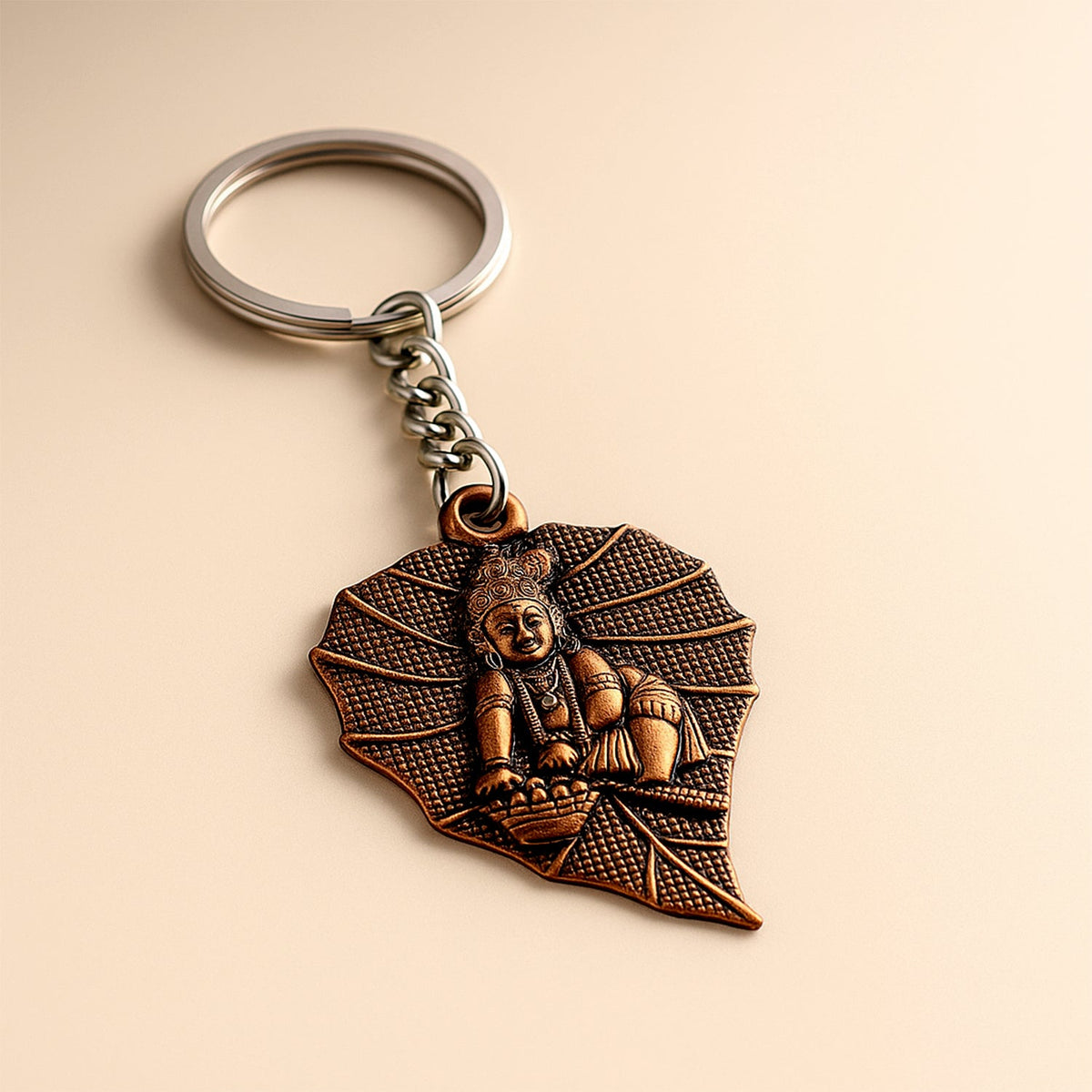 Bal Krishna keychain with antique bronze finish and peepal leaf design Main image