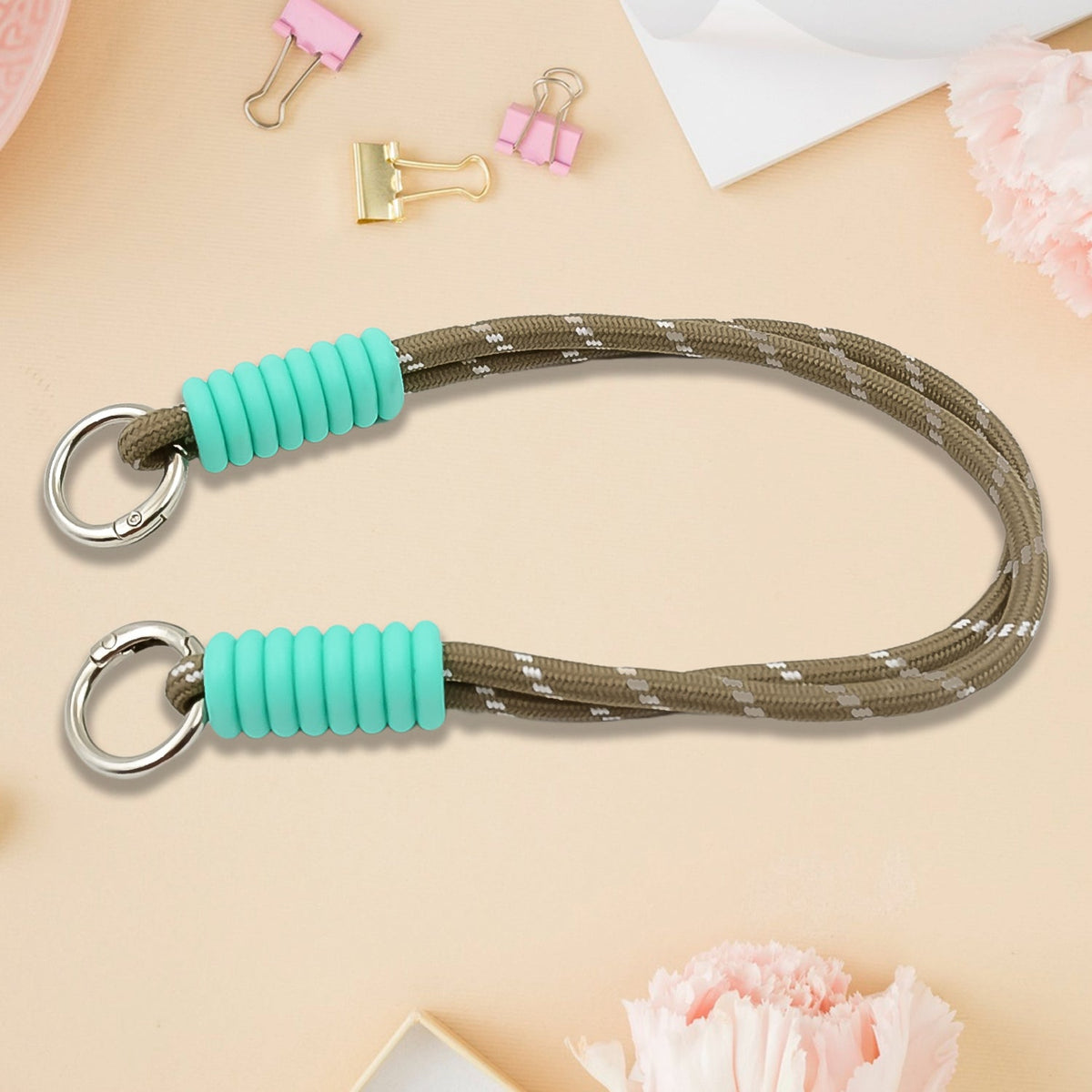 A phone with a vibrant multi-colored phone wrist strap attached, held securely. Main image