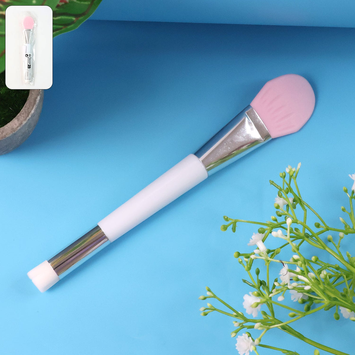 Silicone face mask applicator beauty brush resting on white surface Main image