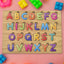 Wooden ABC Puzzle board with colourful letters and shapes for early learning.