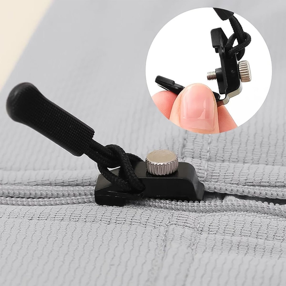 Close-up of the versatile detachable zipper slider in use on a black jacket zipper. Main image