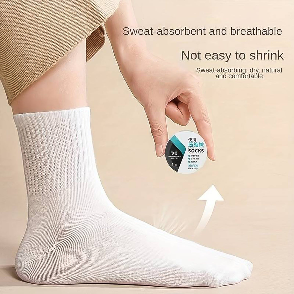 A pair of compact, white disposable travel socks for easy packing. Main image