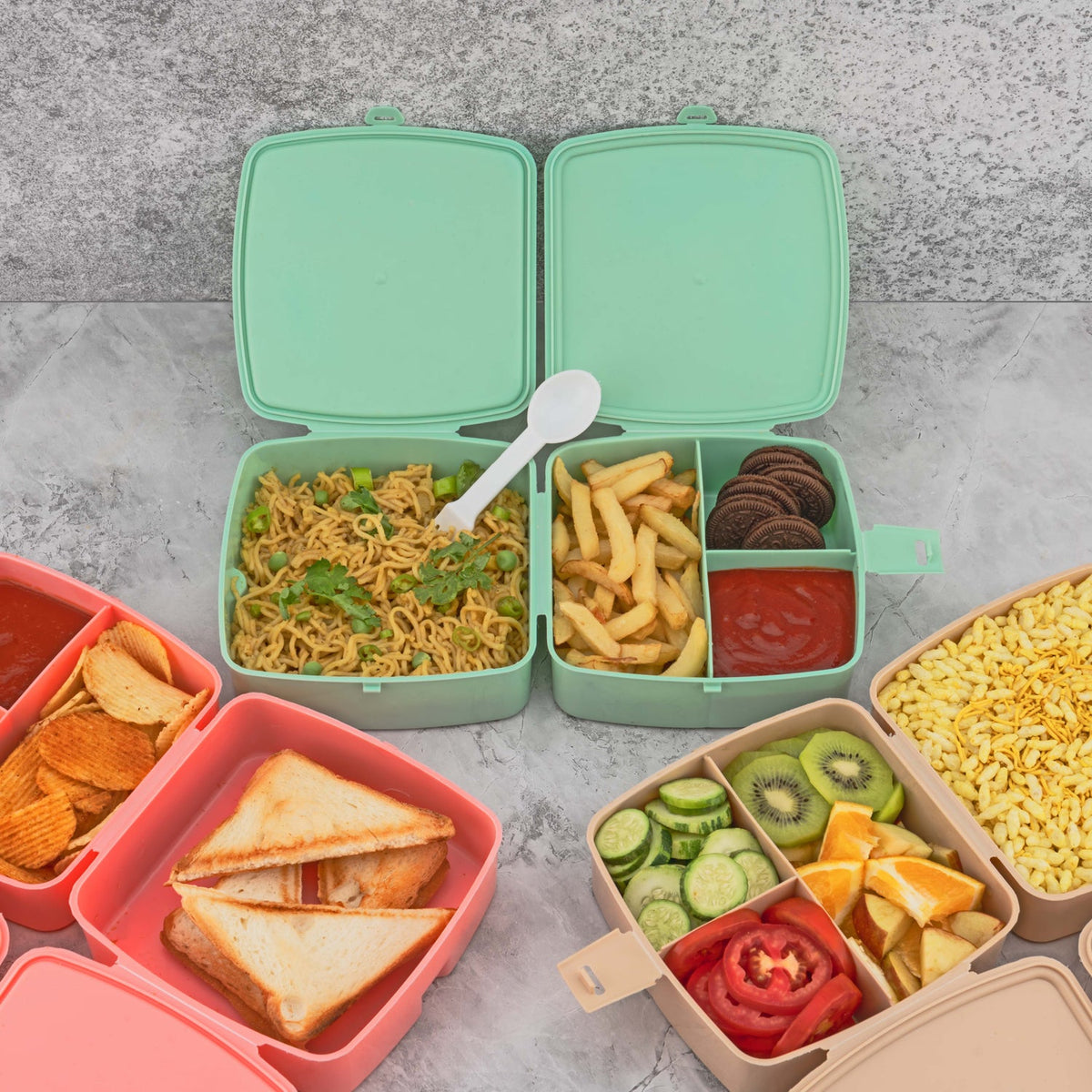 Front view of a blue Double Layer Lunch Box with a spoon and four internal compartments. Main image
