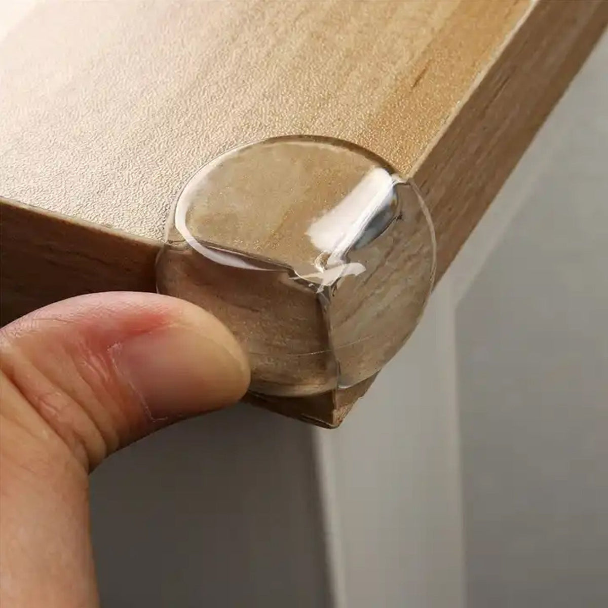 Clear baby corner protectors applied to a table edge for safety. Main image