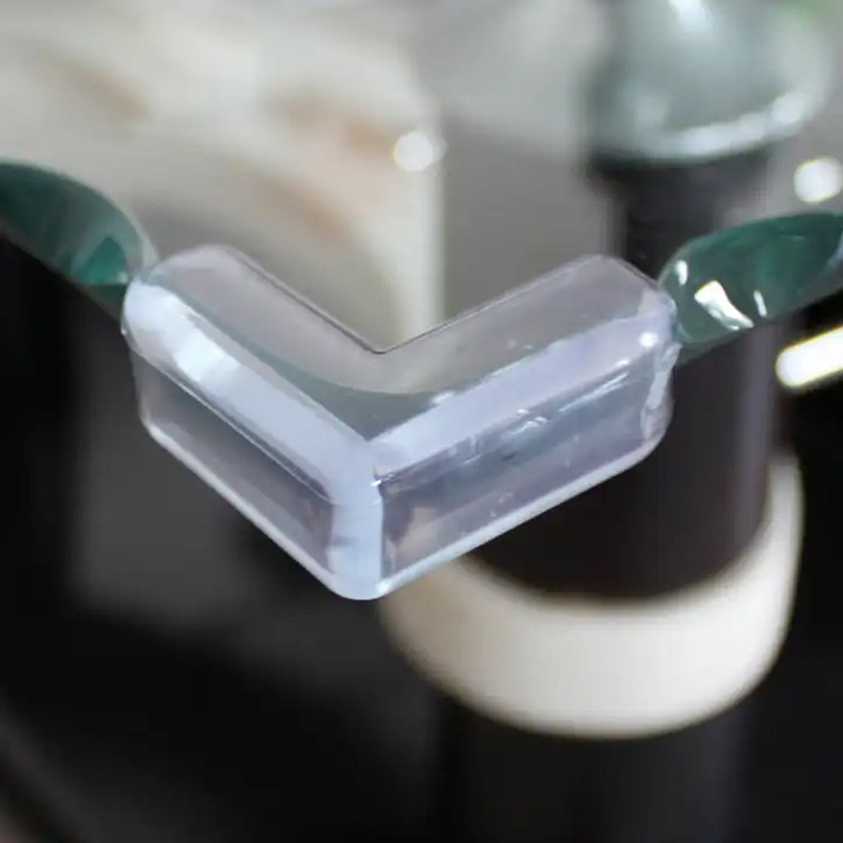 Transparent baby corner protectors (200 pc set) on a wooden table edge. Main image