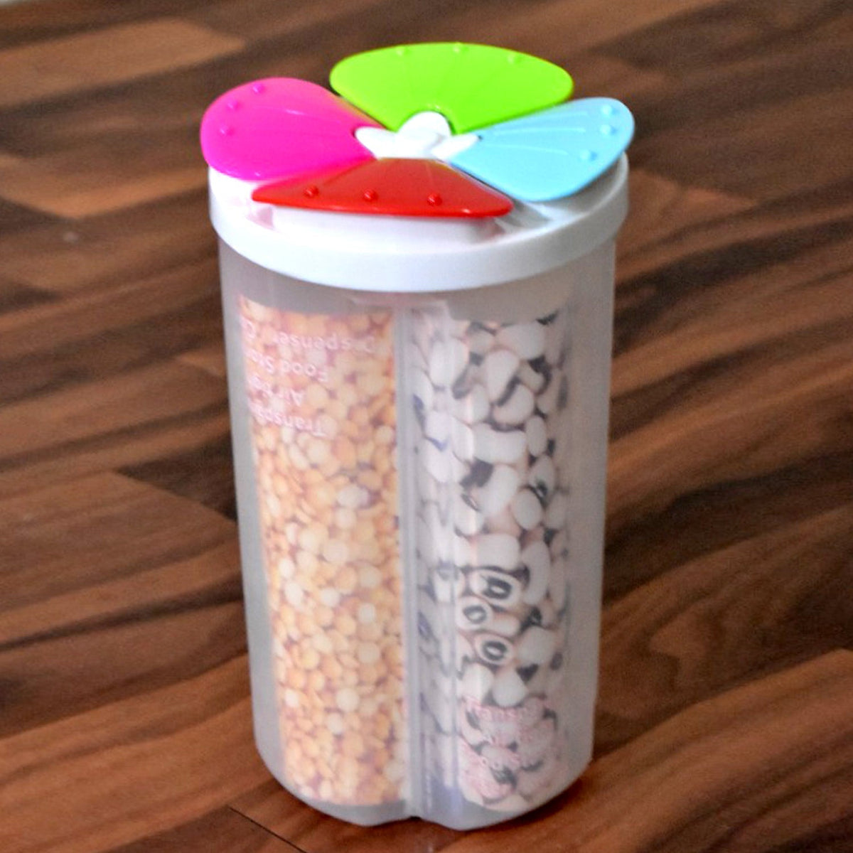 Transparent 4 section storage container with a pink lid, holding various cereals. Main image