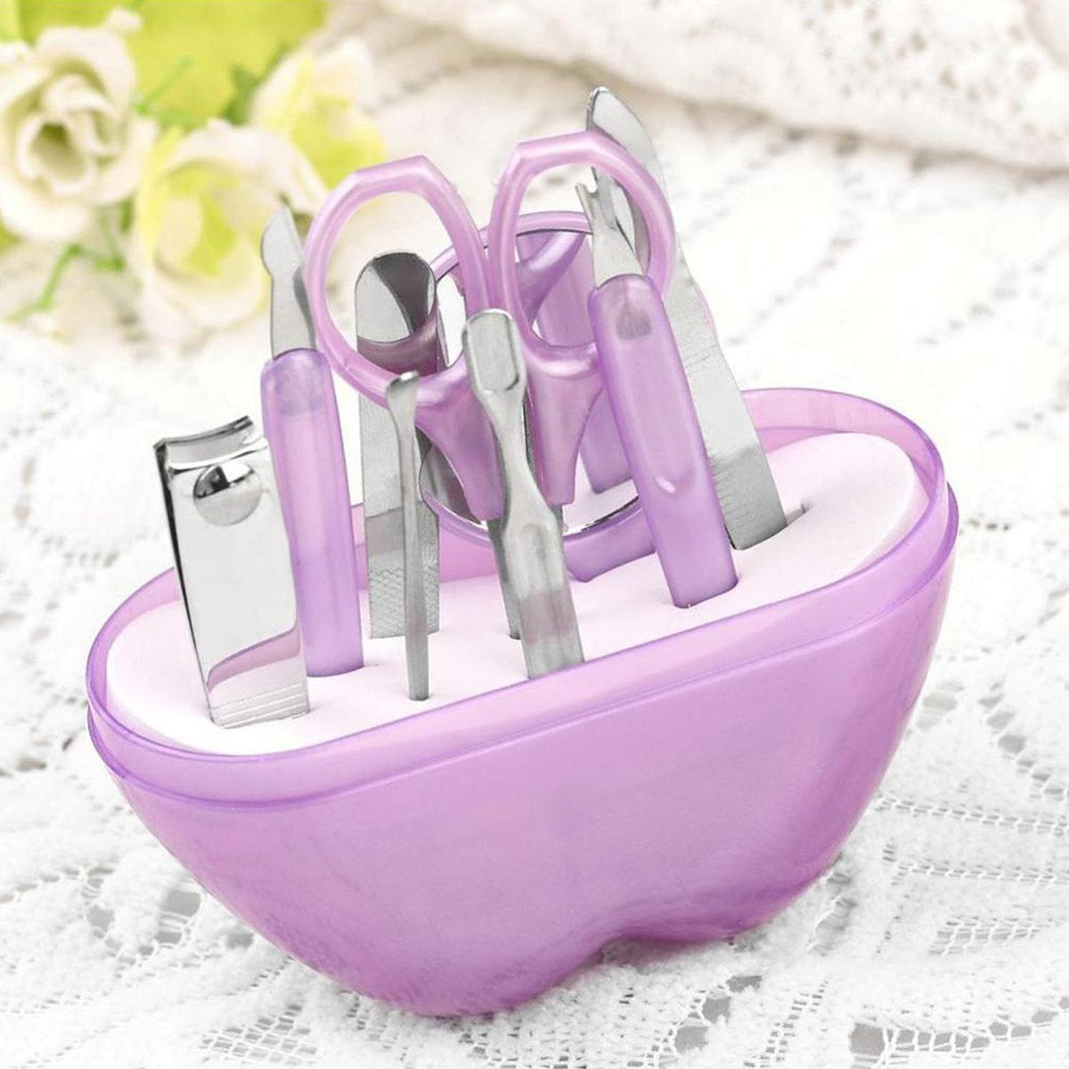 Compact apple-shaped manicure set with 8 stainless steel tools. Main image