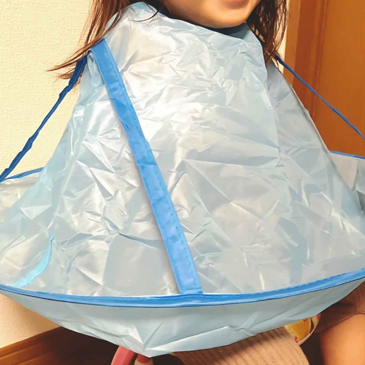 Reusable hair cutting cape with hair-catch guard for mess-free haircuts Main image
