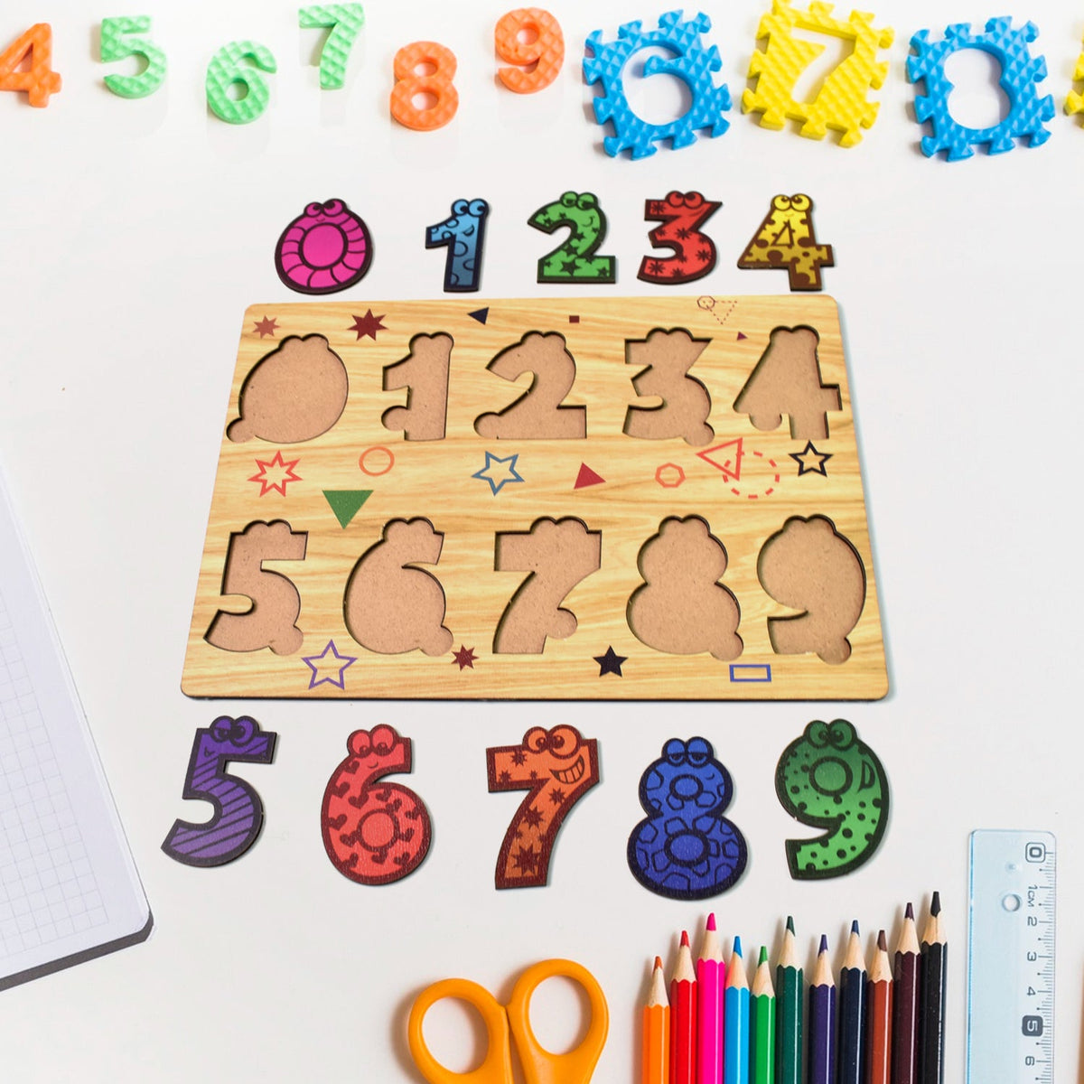 Toddler happily playing with a colorful wooden number puzzle board. Main image