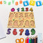 Toddler happily playing with a colorful wooden number puzzle board.
