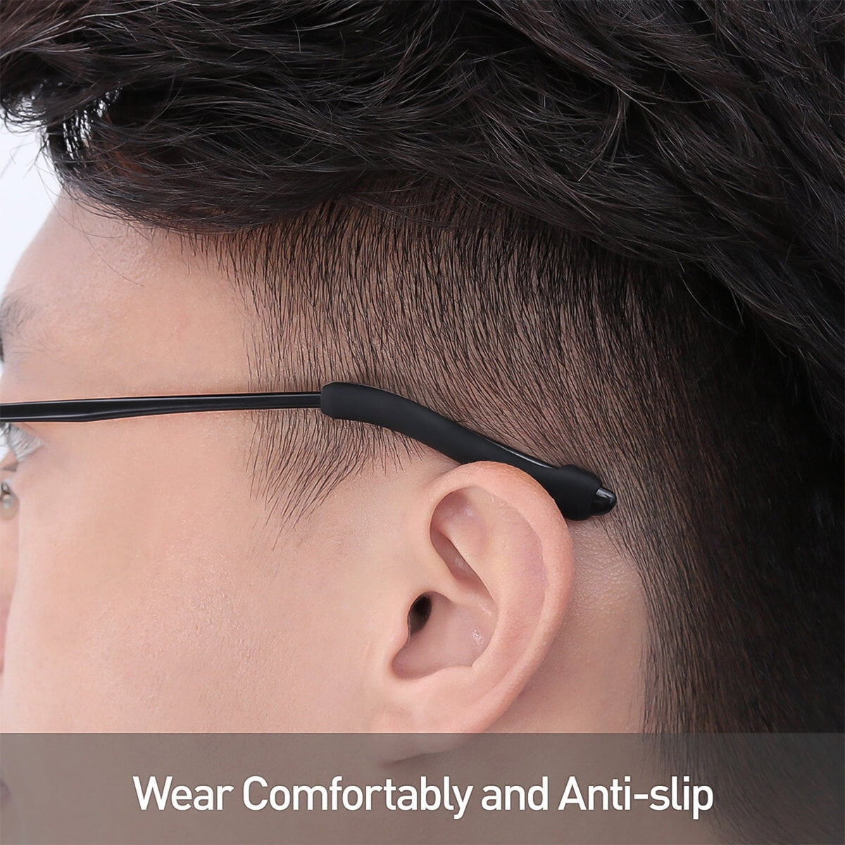 Anti-slip silicone eyeglass ear grips fitted on black-framed glasses, viewed from the side. Main image