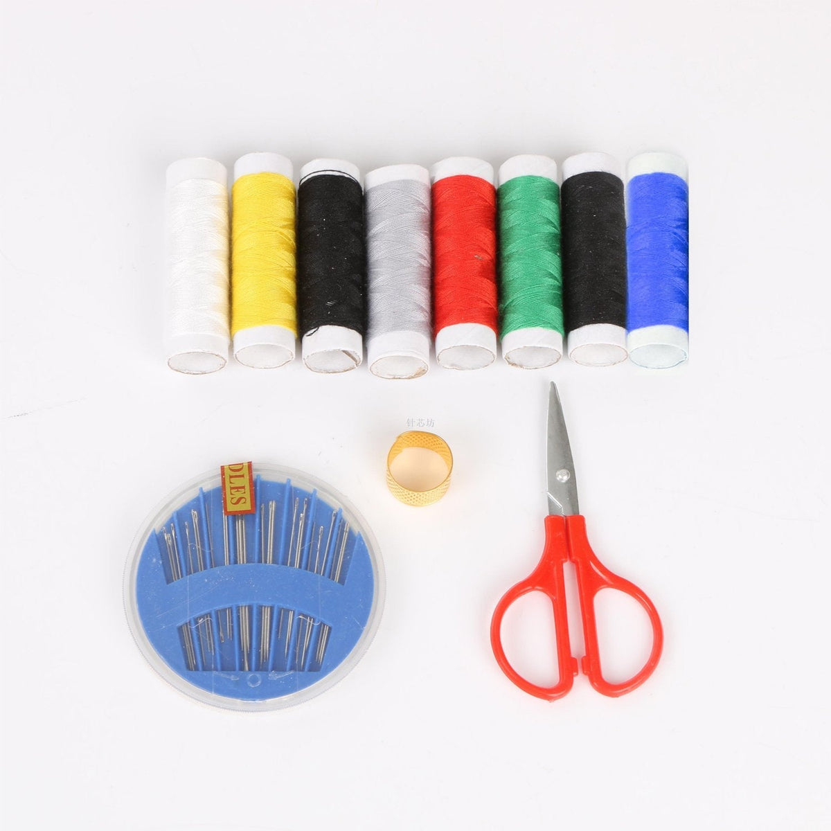 Sewing kit for home tailoring with bobbins, threads, and scissors. Main image