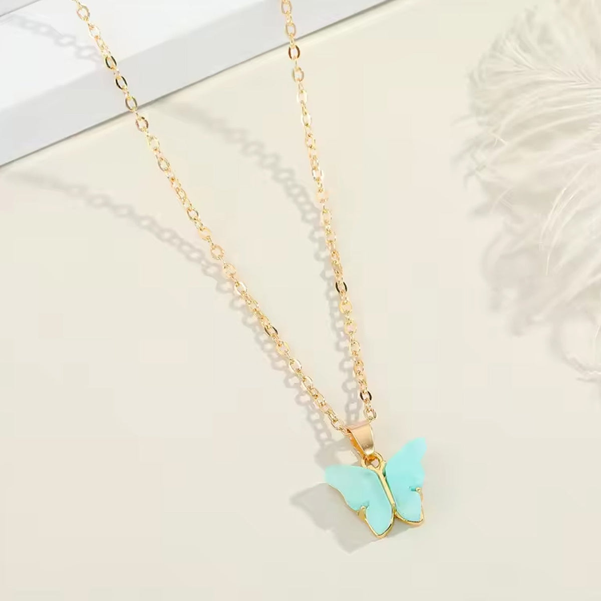 Assorted charm chain necklace with pink hearts and butterflies. Main image